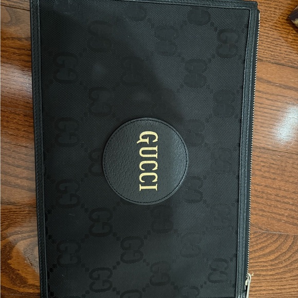 Gucci Handbags - Gucci Black Pouch with Gold Emblem